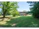 Spacious backyard with grassy area and mature trees at 1571 Branchville Rd, Shelby, NC 28150