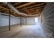 Unfinished basement with window and storage area at 1571 Branchville Rd, Shelby, NC 28150