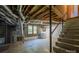 Unfinished basement area with exposed pipes and stairs at 1571 Branchville Rd, Shelby, NC 28150