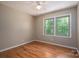 Bright bedroom with hardwood floors, ceiling fan, and large windows at 1571 Branchville Rd, Shelby, NC 28150