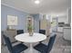 Modern dining room with adjacent kitchen and white round table at 1571 Branchville Rd, Shelby, NC 28150