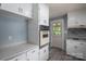 Clean kitchen with white cabinets, built-in oven, and gray countertops at 1571 Branchville Rd, Shelby, NC 28150