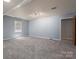 Spacious living room with gray walls and gray carpeting at 1571 Branchville Rd, Shelby, NC 28150