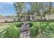 A backyard featuring a fountain, sculpted hedges, and a well-maintained garden at 235 Walnut St, Statesville, NC 28677