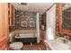 Vintage bathroom with clawfoot tub, patterned wallpaper, and traditional fixtures at 235 Walnut St, Statesville, NC 28677