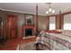 Comfortable bedroom with a decorative fireplace, wood floors, and four-poster bed at 235 Walnut St, Statesville, NC 28677