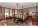 Spacious bedroom with a four-poster bed, wood floors, and decorative area rug at 235 Walnut St, Statesville, NC 28677