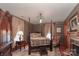 Inviting bedroom with a decorative fireplace, four-poster bed, and classic finishes at 235 Walnut St, Statesville, NC 28677