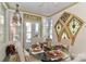 Cozy breakfast nook with stained glass details and an adjacent outdoor porch at 235 Walnut St, Statesville, NC 28677
