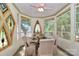 Bright breakfast nook featuring stained glass windows and seating for four guests at 235 Walnut St, Statesville, NC 28677