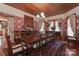 Stately dining room with a large wooden table, ornate chairs, and decorative wallpaper at 235 Walnut St, Statesville, NC 28677