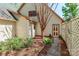 Shows the side of the home with a garden area, walkway, and an exterior door at 235 Walnut St, Statesville, NC 28677