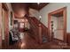 Inviting foyer with a grand staircase, hardwood floors, and period lighting at 235 Walnut St, Statesville, NC 28677