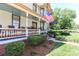 Inviting porch view showcasing the landscaped yard and mature foliage at 235 Walnut St, Statesville, NC 28677
