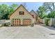 Exterior shot of a two-car garage with decorative doors and well-maintained landscaping at 235 Walnut St, Statesville, NC 28677