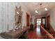 Upstairs hallway with hardwood floors, a large decorative mirror, and ceiling accents at 235 Walnut St, Statesville, NC 28677
