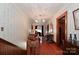 Hallway with hardwood floors, vintage wallpaper, and decorative ceiling at 235 Walnut St, Statesville, NC 28677