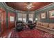 Cozy living room with dark green walls, wood ceiling, leather chairs, and a decorative rug at 235 Walnut St, Statesville, NC 28677