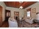 Elegant living room with decorative wallpaper, hardwood ceiling, fireplace, and plush seating at 235 Walnut St, Statesville, NC 28677