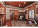 Cozy living room with fireplace, piano, and vintage furniture at 235 Walnut St, Statesville, NC 28677