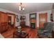 Cozy living room with a fireplace, wood floors, and classic architectural details at 235 Walnut St, Statesville, NC 28677