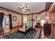Main bedroom showcasing a four-poster bed, elegant decor, and cozy seating area at 235 Walnut St, Statesville, NC 28677