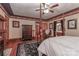 Spacious main bedroom with four-poster bed, hardwood floors, and ensuite bathroom at 235 Walnut St, Statesville, NC 28677