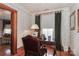 Charming office with decorative wallpaper, vintage desk, and window with curtains at 235 Walnut St, Statesville, NC 28677