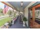 Wide front porch perfect for relaxation, featuring rocking chairs and potted plants at 235 Walnut St, Statesville, NC 28677