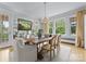 Bright dining room with large windows, hardwood floors, and a rustic table at 215 N Main St, Belmont, NC 28012