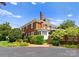 Two-story brick home with mature landscaping and a private driveway at 215 N Main St, Belmont, NC 28012