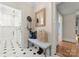 Convenient laundry room with white cabinets and black and white tile floor at 215 N Main St, Belmont, NC 28012