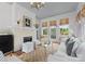 Cozy living room features a fireplace, and French doors opening to a garden at 215 N Main St, Belmont, NC 28012