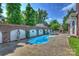 Pool and hot tub surrounded by brick wall and landscaping at 215 N Main St, Belmont, NC 28012