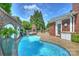 Luxury pool and hot tub with brick details at 215 N Main St, Belmont, NC 28012