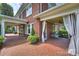Spacious covered porch with brick flooring at 215 N Main St, Belmont, NC 28012