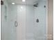 Modern shower with white herringbone tile and glass enclosure at 215 N Main St, Belmont, NC 28012