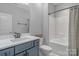 Clean bathroom with a white tub, gray vanity, and modern fixtures at 4212 Linville Way, Fort Mill, SC 29707