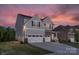 Two-story house with gray siding, stone accents, and a three-car garage at 4212 Linville Way, Fort Mill, SC 29707