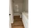 Bright bathroom featuring a tub/shower combo, white vanity, and laminate flooring at 814 W Raleigh W Ave, Statesville, NC 28677