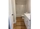 Clean bathroom with a white vanity, toilet, and shower-tub combination, complemented by wood-look flooring at 814 W Raleigh W Ave, Statesville, NC 28677