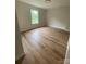 This bedroom has a window, wood floor, and light-colored walls at 814 W Raleigh W Ave, Statesville, NC 28677