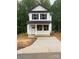 Charming two-story home with a covered porch and freshly poured concrete driveway at 814 W Raleigh W Ave, Statesville, NC 28677