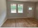 Sun-filled room with new hardwood floors, white walls, and windows with views to the yard at 814 W Raleigh W Ave, Statesville, NC 28677