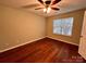 Well lit bedroom with wood flooring, a window, and a ceiling fan at 10875 Holly Ridge Blvd, Charlotte, NC 28216