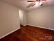 This bedroom features neutral walls, wood-look floors, and a ceiling fan at 10875 Holly Ridge Blvd, Charlotte, NC 28216