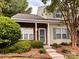 Charming two-story townhome featuring brick accents and a well-maintained front yard at 10875 Holly Ridge Blvd, Charlotte, NC 28216
