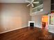 Spacious living room with high ceilings, fireplace, and wood flooring at 10875 Holly Ridge Blvd, Charlotte, NC 28216