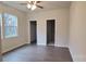 Bedroom featuring hardwood floors, a ceiling fan, and ample closet space at 2668 Meadow St, Gastonia, NC 28056