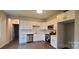 Modern kitchen featuring white cabinets, stainless steel appliances, and hardwood floors at 2668 Meadow St, Gastonia, NC 28056